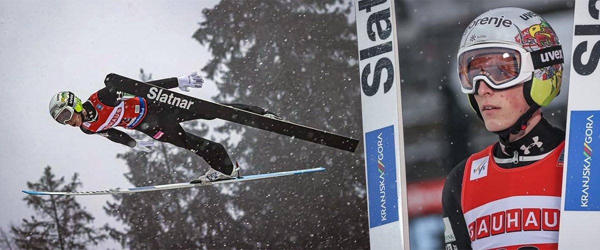 Smučarski skakalec v poletu med sneženjem